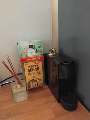 a shelf with books and a stove and a box at Embassy Apartment in Sofia