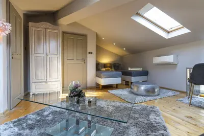 a living room with a glass table and a couch at ArtCity Villa - 3 Boutique Suits in Historic town in Plovdiv