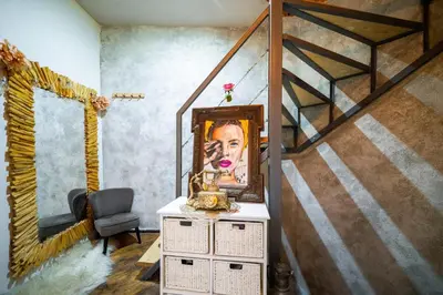 a painting of a woman on a dresser in a room at ArtCity Villa - 3 Boutique Suits in Historic town in Plovdiv