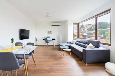 a living room with a couch and a table at Domus Apartments Old Town with Garage in Plovdiv