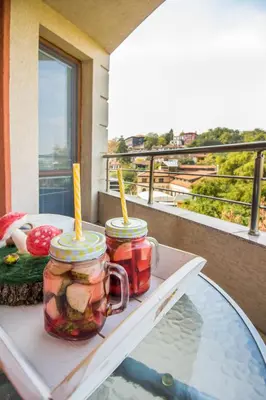 two jars of pickles on a table on a balcony at Domus Apartments Old Town with Garage in Plovdiv