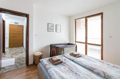 a bedroom with a large bed with towels on it at Domus Apartments Old Town with Garage in Plovdiv