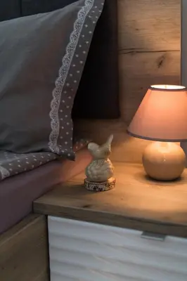 a lamp sitting on a night stand next to a bed at Domus Apartments Old Town with Garage in Plovdiv