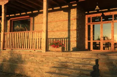 a brick house with a flower pot on the porch at Leshten Guest Homes in Leshten