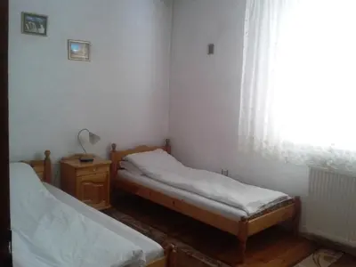 a small room with two beds and a window at Tsvetkovi Guest House in Dobrinishte