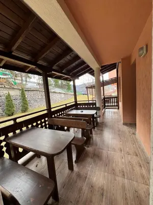 a row of tables and benches in a train station at Panorama Guest House in Smolyan