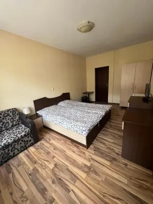 a bedroom with a bed and a couch at Panorama Guest House in Smolyan
