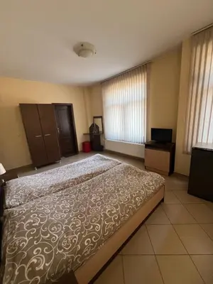 a bedroom with a large bed in a room at Panorama Guest House in Smolyan