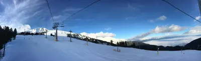 a snow covered ski slope with a ski lift at Entire Private Apartment in Pirin Golf & Country Club in Bansko