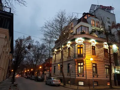a large wooden building on the side of a street at СКЕРЦО SkerZZo Guest House in Plovdiv