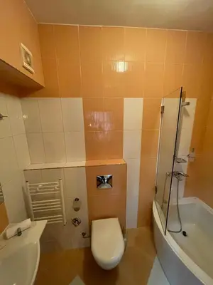 a bathroom with a toilet and a sink and a tub at СКЕРЦО SkerZZo Guest House in Plovdiv