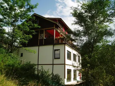 a house with a balcony on top of it at Villa AdiArt in Arda