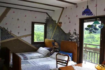 a bedroom with two beds and a staircase at Villa AdiArt in Arda