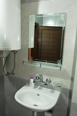 a bathroom with a sink and a mirror at Studio Manushev in Sandanski
