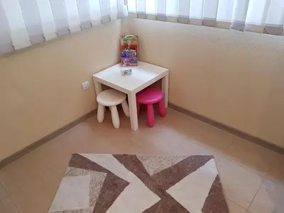 a small table and two chairs in a room at United Apartments in Sandanski