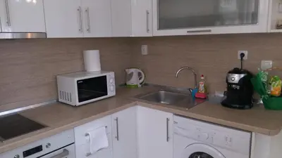 a kitchen with a sink and a microwave at United Apartments in Sandanski