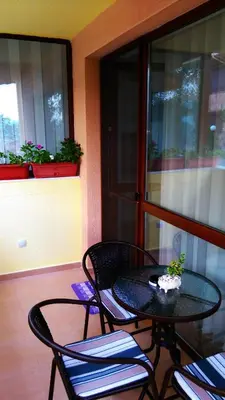 a patio table and chairs on a balcony at United Apartments in Sandanski
