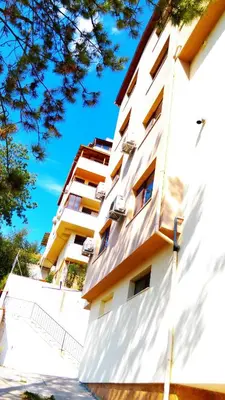 a white building with windows on the side of it at United Apartments in Sandanski