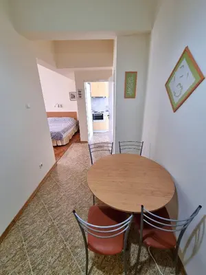 a dining room with a table and chairs and a bedroom at Asen 36 Apartment in Sofia