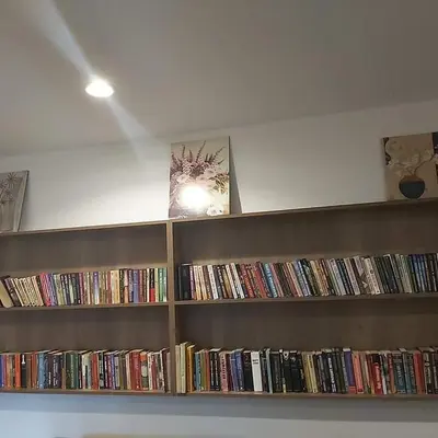 a book shelf filled with lots of books at Park Hotel Eagle Stone in Koprivshtitsa