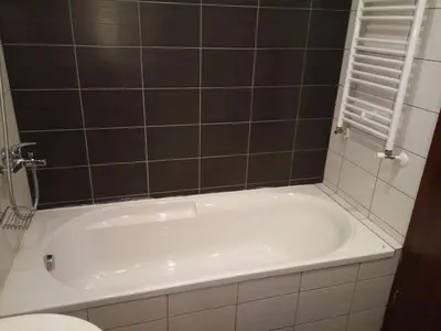 a white tub in a bathroom with a toilet at Studio in Borovets Gardens Complex in Borovets