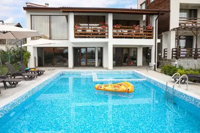 a swimming pool in front of a house at Guest House Ognyanovo in Ognyanovo