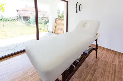 a white bed in a room with a window at Guest House Ognyanovo in Ognyanovo