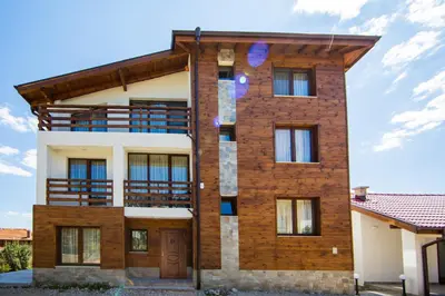 a tall brick building with a balcony at Guest House Ognyanovo in Ognyanovo