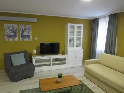 a living room with a couch and a tv at Villa Park Apartment nr 216 in Borovets