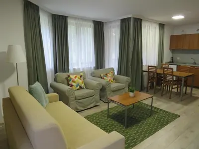 a living room with a couch and a table at Villa Park Apartment nr 216 in Borovets
