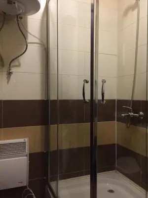 a shower with a glass door in a bathroom at Mountain Top Mina in Bansko