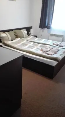 a large bed in a room with a black frame at Mountain Top Mina in Bansko
