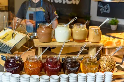 a group of jars of jam on a wooden table at Hotel Arte SPA & Park in Velingrad