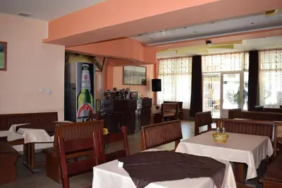 a restaurant with tables and chairs in a room at Complex Pele in Zmeitsa