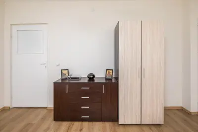 a wooden cabinet in a room with a desk at Apartments Ivadoni in Velingrad