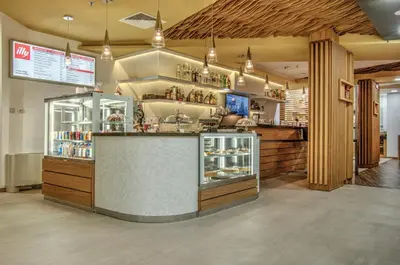 a restaurant with a counter in a room at Holiday Inn Plovdiv by IHG in Plovdiv