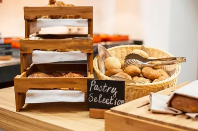 a basket of bread and a sign on a table at Holiday Inn Plovdiv by IHG in Plovdiv