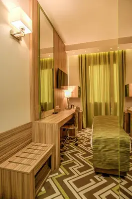 a hotel room with a desk and a bed at Holiday Inn Plovdiv by IHG in Plovdiv