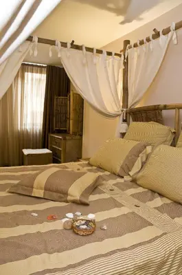 a bedroom with a large bed with a canopy at Hotel 4 Zona in Sofia