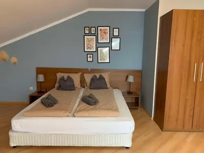 a bedroom with a large bed with pillows on it at Villa Park Studio Apartment nr 409 in Borovets