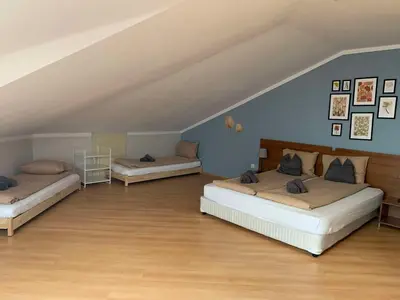 two beds in a room with blue walls and wooden floors at Villa Park Studio Apartment nr 409 in Borovets