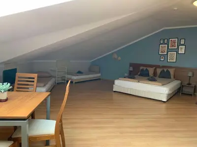 a living room with two beds and a table at Villa Park Studio Apartment nr 409 in Borovets