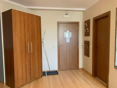 a room with two wooden cabinets and a door at Villa Park Studio Apartment nr 409 in Borovets
