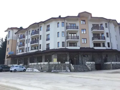 a building with a car parked in front of it at Villa Park Studio Apartment nr 409 in Borovets