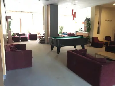 a living room with a pool table and couches at Villa Park Studio Apartment nr 409 in Borovets