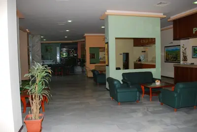 a lobby of a hospital with chairs and tables at Hotel Velbazhd in Kyustendil
