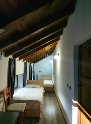 a bedroom with two beds in a room with a ceiling at Danailovi Guest House in Sapareva Banya