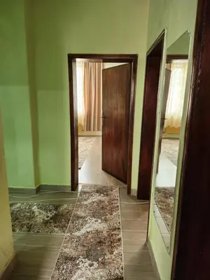 an empty room with two doors and a tile floor at Apartment Lachevi in Sandanski