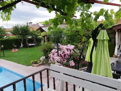 a view of a garden from the balcony of a house at Family hotel Gradina in Ognyanovo