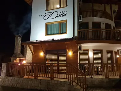 a building with a sign on the side of it at Yuliya Guest House in Sapareva Banya